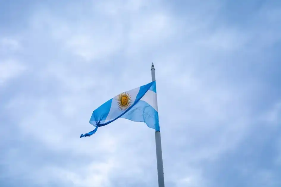 Argentinian flag waving against a cloudy sky