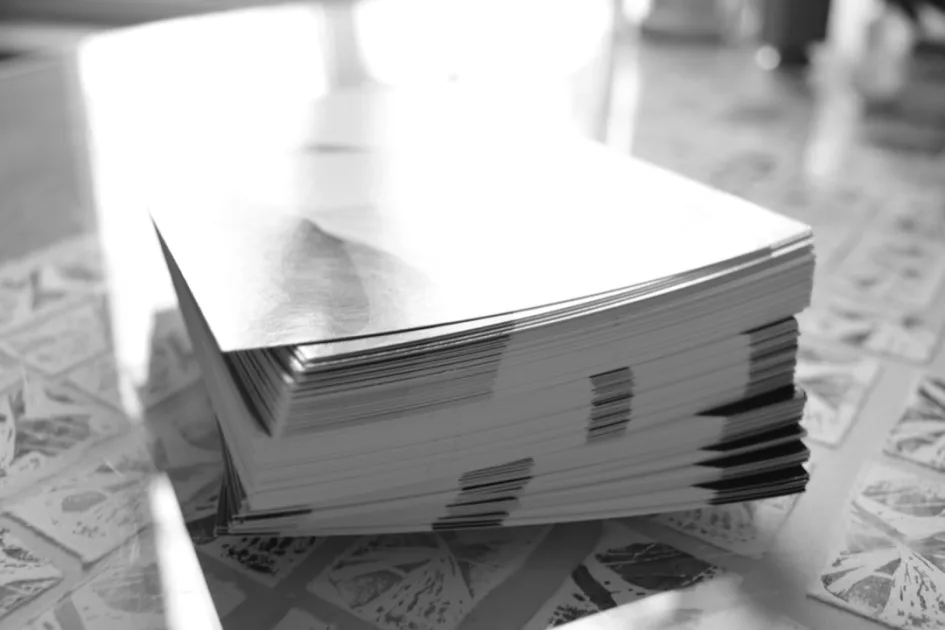 grayscale photo of books on table