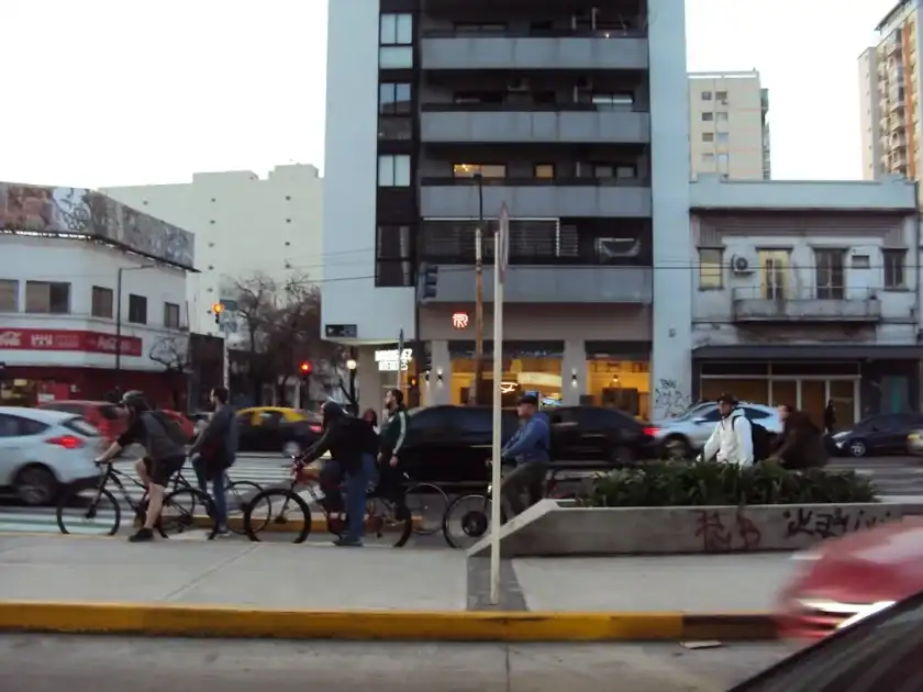 a group of people riding bikes down a street