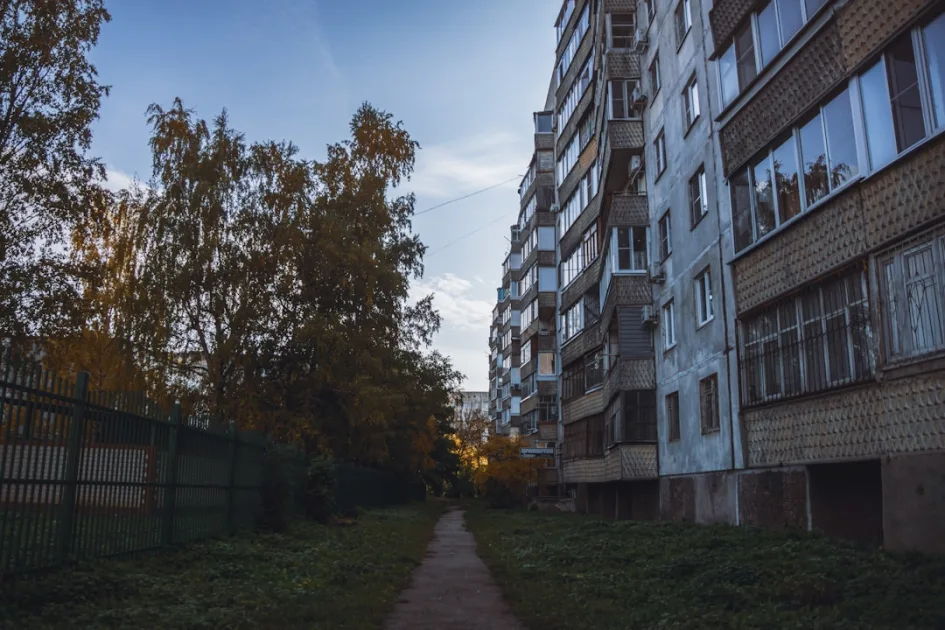 Apartment building with trees and a sidewalk