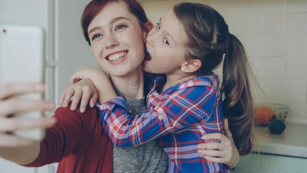 Mother and daughter take a selfie together.
