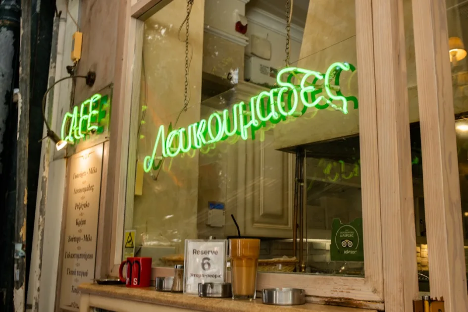 Green neon sign for loukoumades cafe in athens