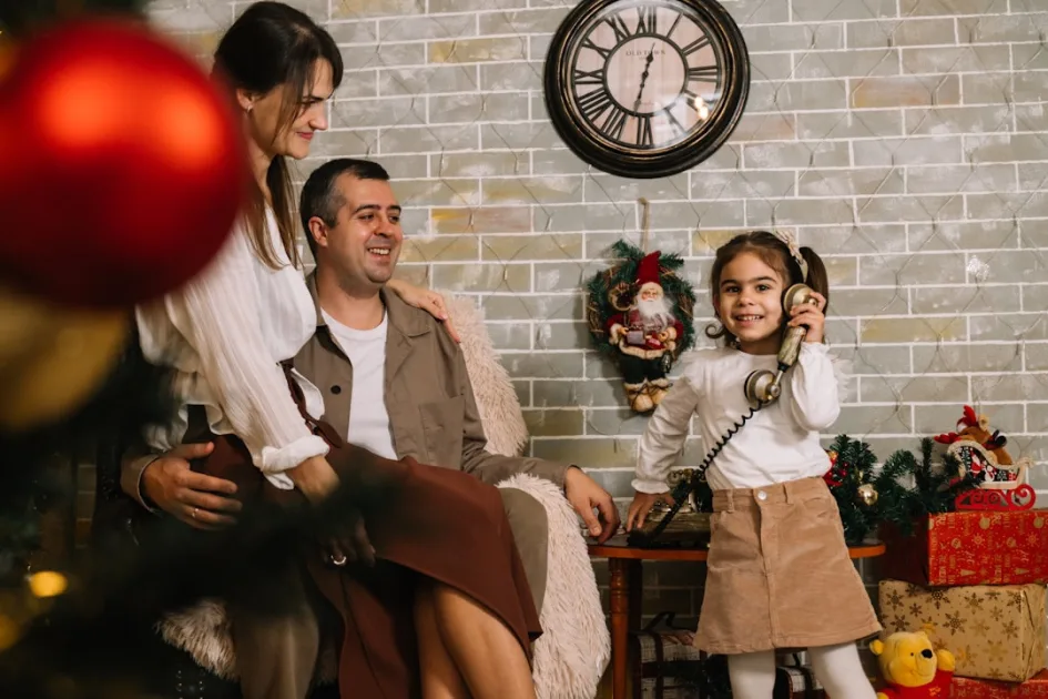 A group of people sitting around a christmas tree